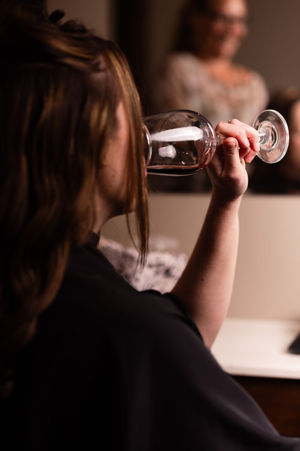 A guest enjoying a glass of red wine