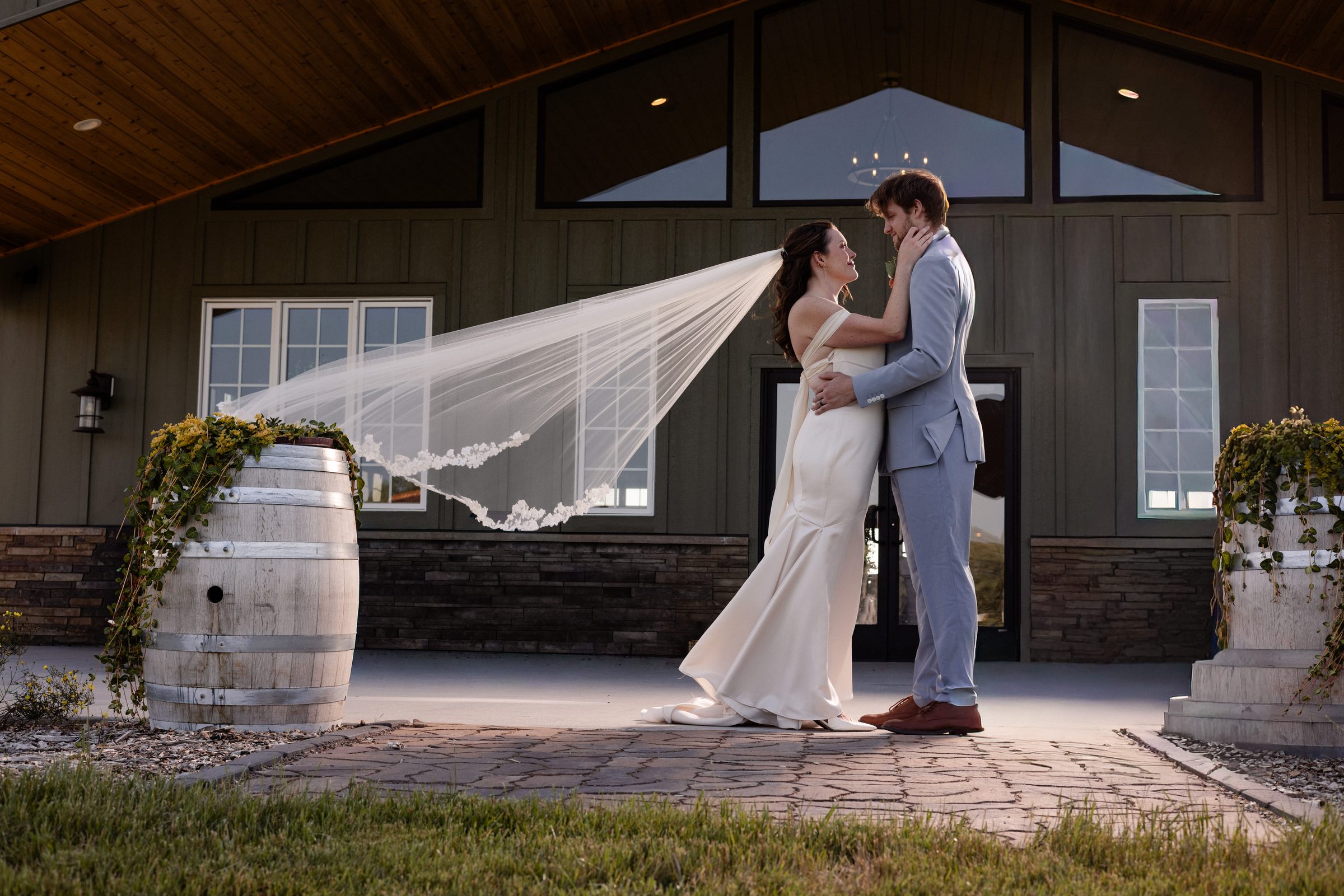 A bride and groom outside Northern Hollow Winery, her veil catching the evening light