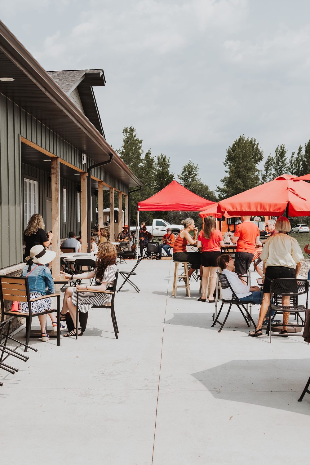 Guests gathered on the winery patio under umbrellas